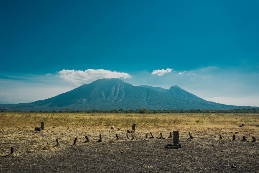 Scenic view of Mount Karisimbi in Volcanoes National Park, Rwanda, showing its rugged peaks under a clear blue sky, photographed on a Rordrave Tours and Travel adventure.